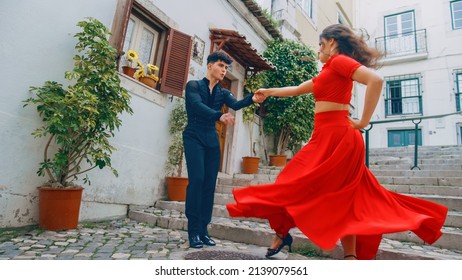 Beautiful Couple Dancing A Latin Dance On The Quiet Street Of An Old Town In A City. Sensual Dance By Two Professional Dancers On A Sunny Day Outside In Ancient Culturally Rich Tourist Location.