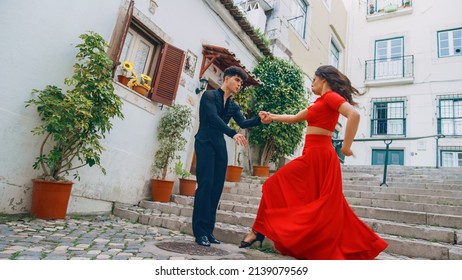 Beautiful Couple Dancing A Latin Dance On The Quiet Street Of An Old Town In A City. Sensual Dance By Two Professional Dancers On A Sunny Day Outside In Ancient Culturally Rich Tourist Location.