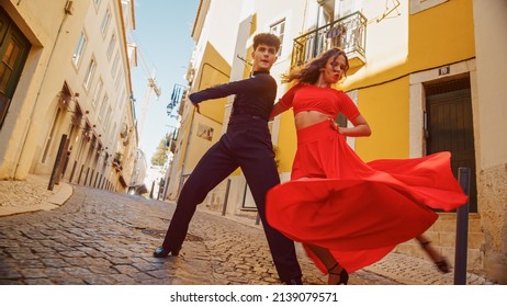 Beautiful Couple Dancing A Latin Dance On The Quiet Street Of An Old Town In A City. Sensual Dance By Two Professional Dancers On A Sunny Day Outside In Ancient Culturally Rich Tourist Location.