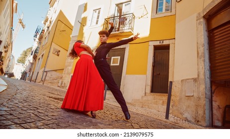 Beautiful Couple Dancing A Latin Dance On The Quiet Street Of An Old Town In A City. Sensual Dance By Two Professional Dancers On A Sunny Day Outside In Ancient Culturally Rich Tourist Location.