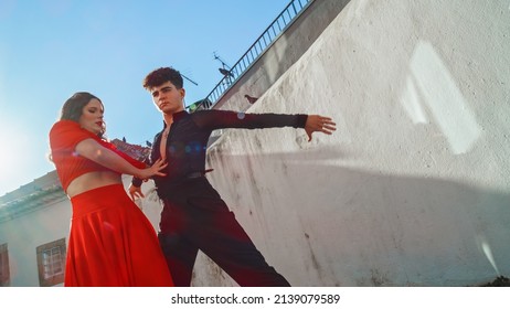 Beautiful Couple Dancing A Latin Dance On The Quiet Street Of An Old Town In A City. Sensual Dance By Two Professional Dancers On A Sunny Day Outside In Ancient Culturally Rich Tourist Location.