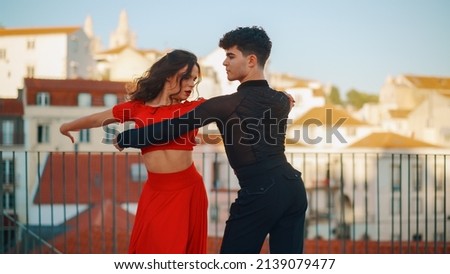 Beautiful Couple Dancing a Latin Dance Outside the City with Old Town in the Background. Sensual Dance by Two Professional Dancers on a Sunset in Ancient Culturally Rich Tourist Location.