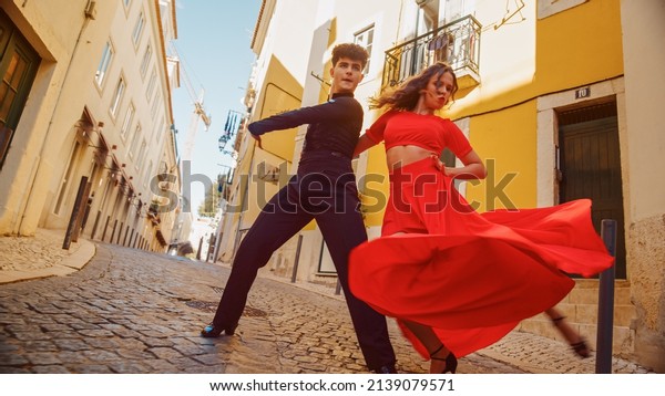 Beautiful Couple Dancing a Latin Dance on the
Quiet Street of an Old Town in a City. Sensual Dance by Two
Professional Dancers on a Sunny Day Outside in Ancient Culturally
Rich Tourist
Location.