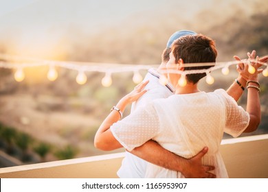 beautiful couple dancing on the terrace rooftop with natural view. love and dating concept for people having romantic leisure activity together with love and tenderness. foreverness concept and sunset - Powered by Shutterstock