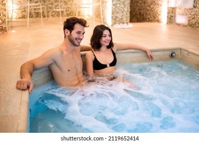 Beautiful couple doing a whirlpool bath in a spa