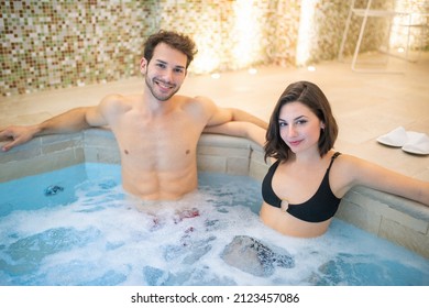 Beautiful couple doing a whirlpool bath in a spa