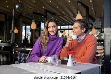 Beautiful couple drinking coffee in cafe bar