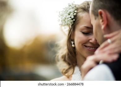 Beautiful Couple Enjoying Embrace Of Each Other And Tenderly Smiling