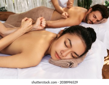 Beautiful couple enjoying sabay massage at oriental spa salon. Sabay Thai-Massage