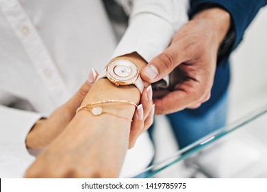 Beautiful Couple Enjoying In Shopping At Modern Jewelry Store. Close Up Shot Of Human Hand Holding Expensive Watch.