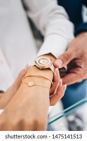 Beautiful Couple Enjoying In Shopping At Modern Jewelry Store. Close Up Shot Of Human Hand Holding Expensive Watch.