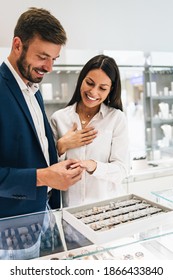 Beautiful Couple Enjoying In Shopping At Modern Jewelry Store. Close Up Shot Of Woman's Hand With Gorgeous Expensive Ring And Bracelet.