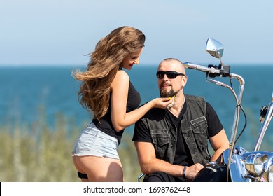 Beautiful Couple Enjoying The Time Together. Happy Bikers In Love. Hot Young Woman In Shorts And Handsome Guy On A Bike