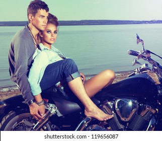 Beautiful Couple Family Sitting On Lake Shore On Motor Bike