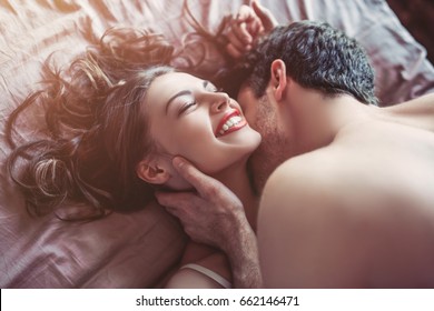 Beautiful Couple Is Having Sex On Bed. Passionate Kiss.