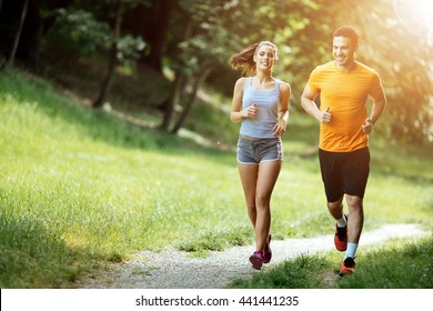 Beautiful couple jogging in nature living healthy - Shutterstock ID 441441235
