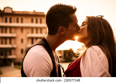 Beautiful Couple Kissing At Sunset.