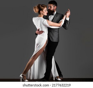 Beautiful Couple In Love Dancing Passionate Dance. Professional Dancers In Elegant Suit And Dress.