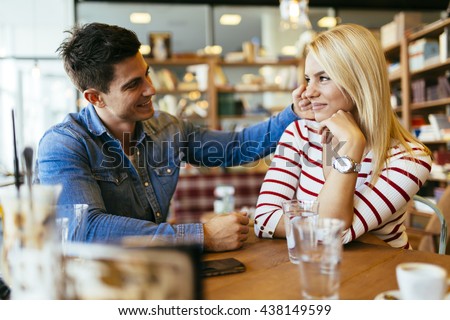 Beautiful couple in love flirting in restaurant and bonding