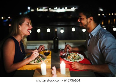 Beautiful Couple In Love Having Romantic Dinner At Night