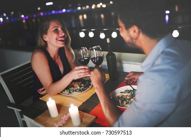 Beautiful couple in love having romantic dinner at night