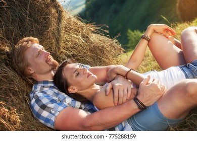 Beautiful couple in love at the hay - Shutterstock ID 775288159
