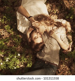 Beautiful Couple Lying In A Meadow In Spring