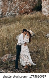 Beautiful Couple In Nature In Boho Style. Wedding In European Style Fine Art At Sunset.