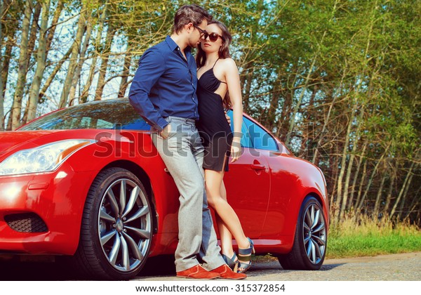 Beautiful couple near the car. Beauty, fashion.\
Love concept.