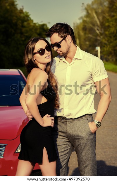Beautiful couple near the car. Beauty, fashion.\
Love concept.