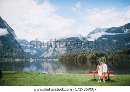 Beautiful couple on a wonderful lake and mountains amazing view