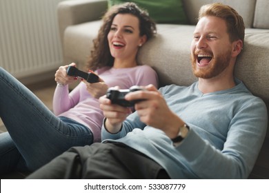 Beautiful Couple Playing Video Games On Console Having Fun