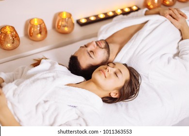 Beautiful Couple Relaxing In Spa Center Lying On Massage Table