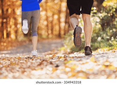 Beautiful Couple Running Outside In Autumn Nature