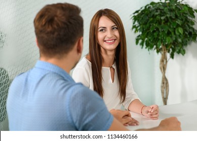 Beautiful couple sitting in dealership. They want to buy new car. - Shutterstock ID 1134460166