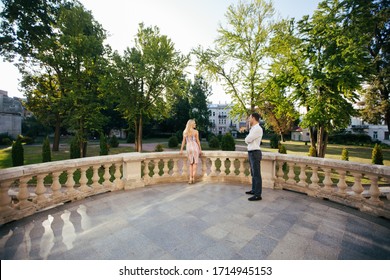 Beautiful Couple Standing On A Chic Balcony