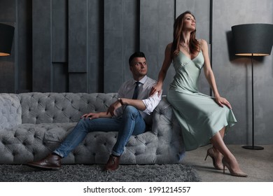 Beautiful Couple In Stylish Living Room. Luxury Lifestyle