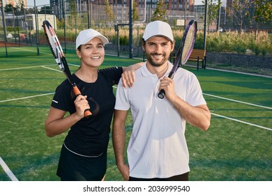 Beautiful couple of tennis players happy after playing tennis outdoors - Powered by Shutterstock