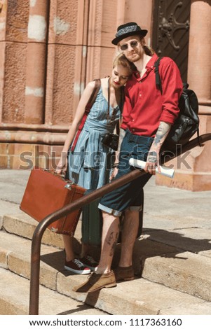 Similar – Couple of tourists walking down the street