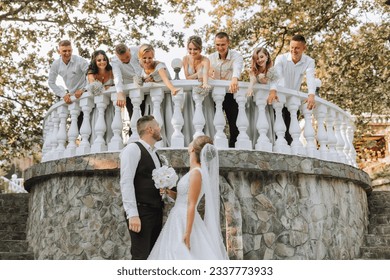 A beautiful couple at a wedding with friends in a beautiful location, staged photo - Powered by Shutterstock