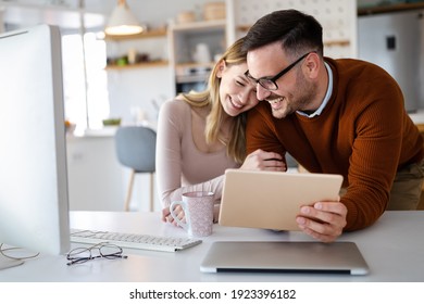Beautiful couple working on a tablet at home