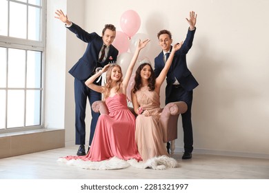 Beautiful couples dressed for prom in room