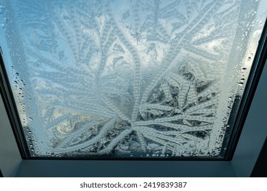 A beautiful creation of nature itself - a drawing on glass due to frost in winter in January early in the morning after dawn. - Powered by Shutterstock