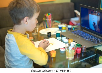 Beautiful creative boy is creativity and the artist in an online drawing paints lesson. Childrens creativity. The concept of distance learning online school for the period of global quarantine.