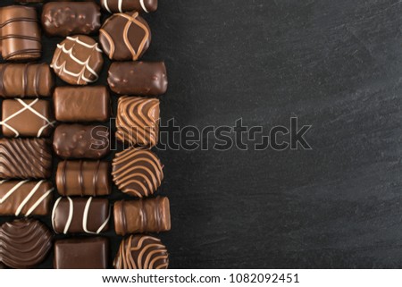 Beautiful Creative Chocolates Candies Background. Chocolate Wallpaper Top View and Flat Lay