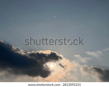  Beautiful crepuscular rays breaking through dark clouds at sunset, sky background with copy space