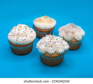 Beautiful Cup Cakes Close Up On Blue Background.