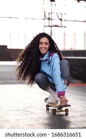 Beautiful Curly Black Girl Rides On A Skateboard. Skate Park