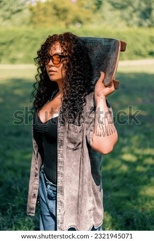 Brunette surfer woman with top holding surfboard