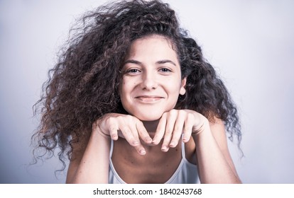 Beautiful Curly Haired Female Model Posing In Studio. Isolated